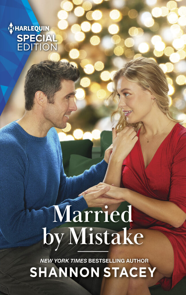 Book cover for Married by Mistake with a man and woman looking tenderly at each other with holiday decorations in the background.