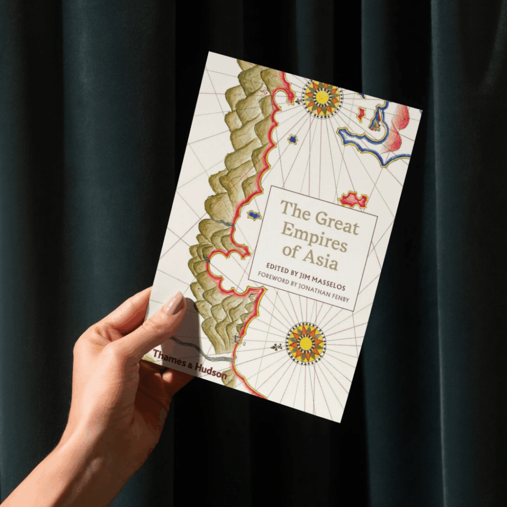 A hand holds a copy of The Great Empires of Asia
